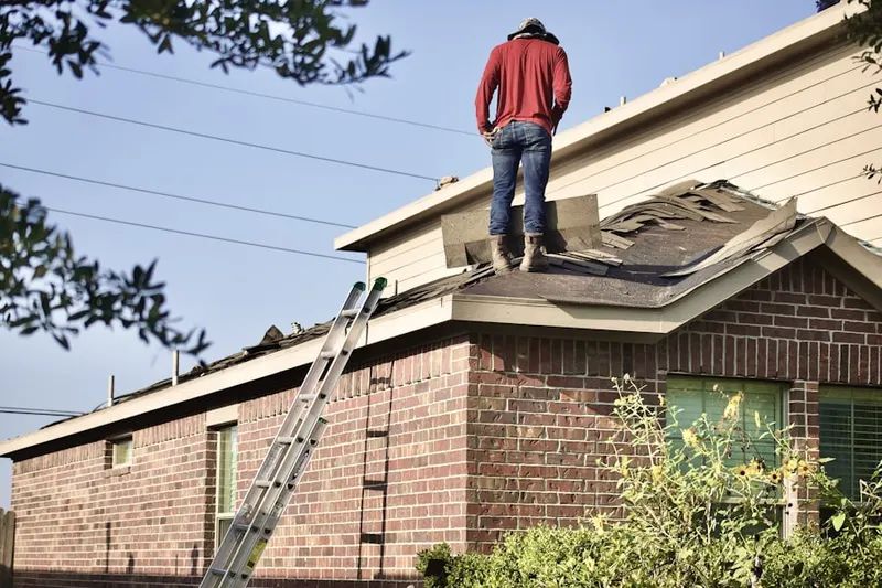 Professional roofer working on a residential roof in Pinewood Place